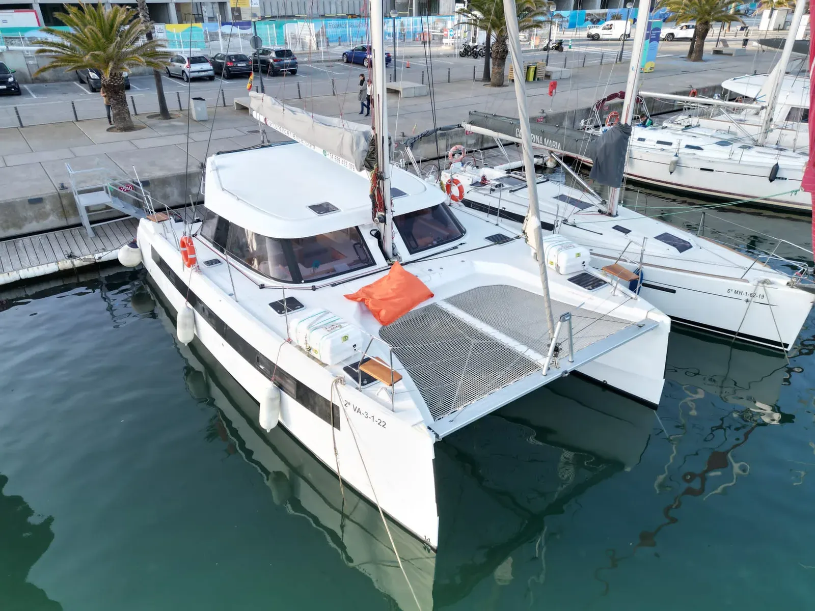 Private catamaran hire in Barcelona – party boat at Port Olímpic with guests on deck