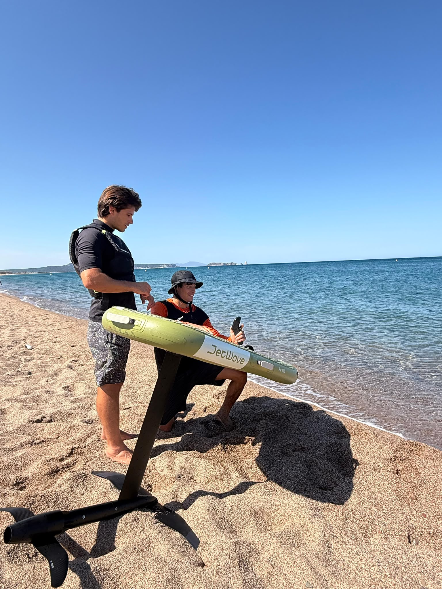 E-foil session on the Costa Brava – electric hydrofoil gliding over turquoise water in a cove