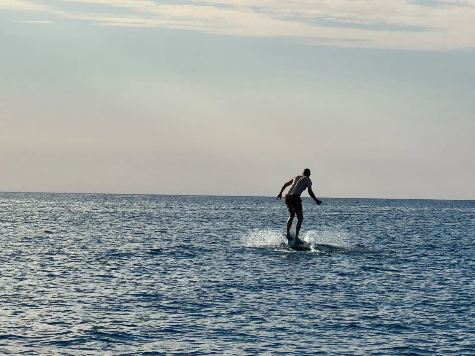 E-foil over turquoise water in a Costa Brava cove