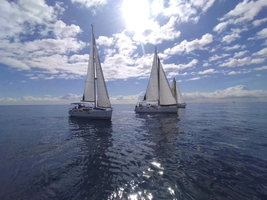 Three sailboats on the regatta field off the Barcelona coast