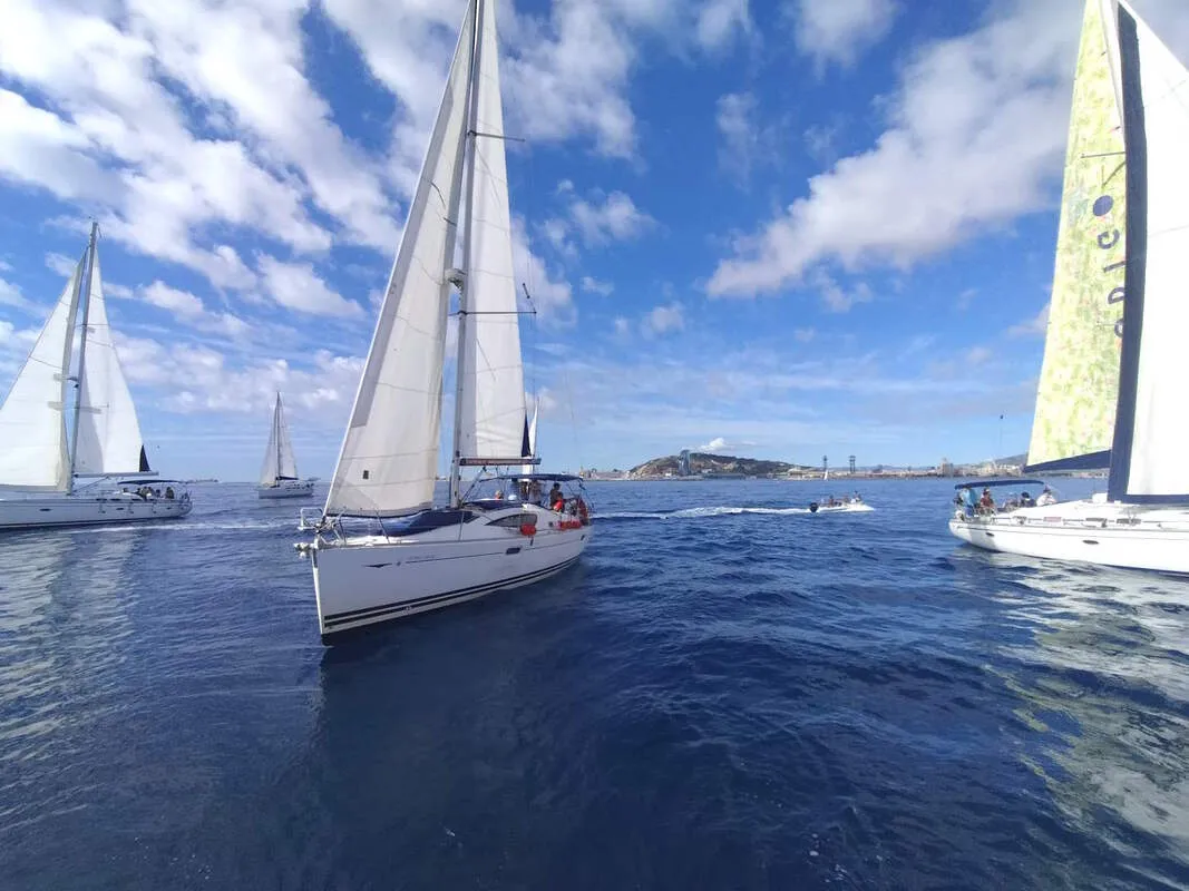 Sailboat and assistant speedboat during the corporate regatta