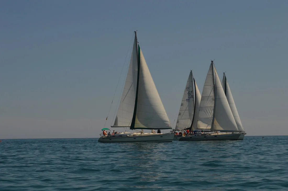 Two sailing boats close together fighting for position at the regatta